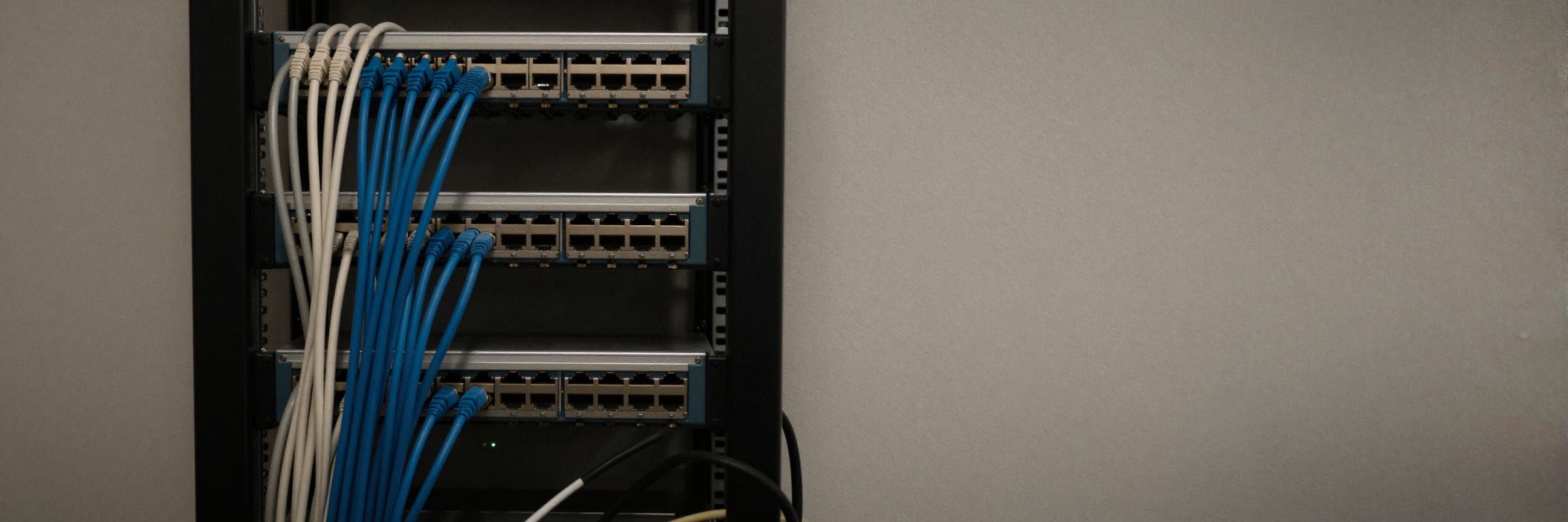 The patch panel of a small business network rack, cables dressed into bundles down one side.